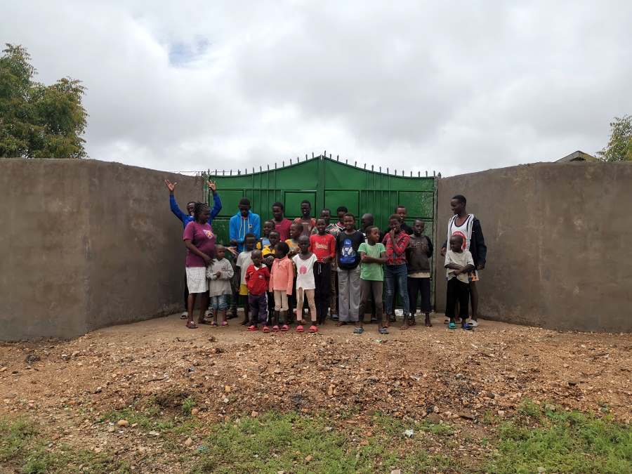 The children prudly present their new gate.